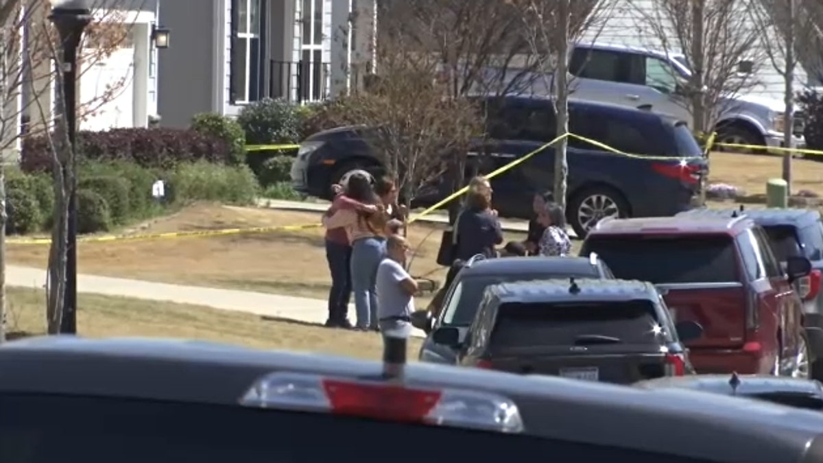 The Samarel family's loved ones gather outside their home on March 28.