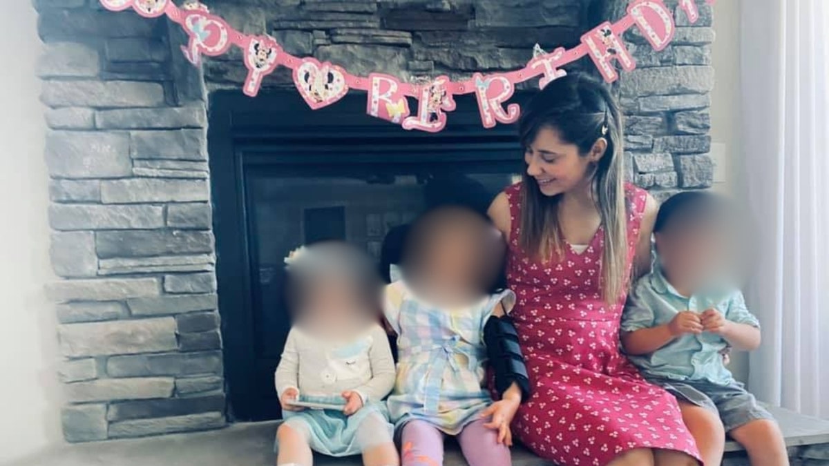 Lina Samarel poses with her three children before a 'Happy Birthday' sign