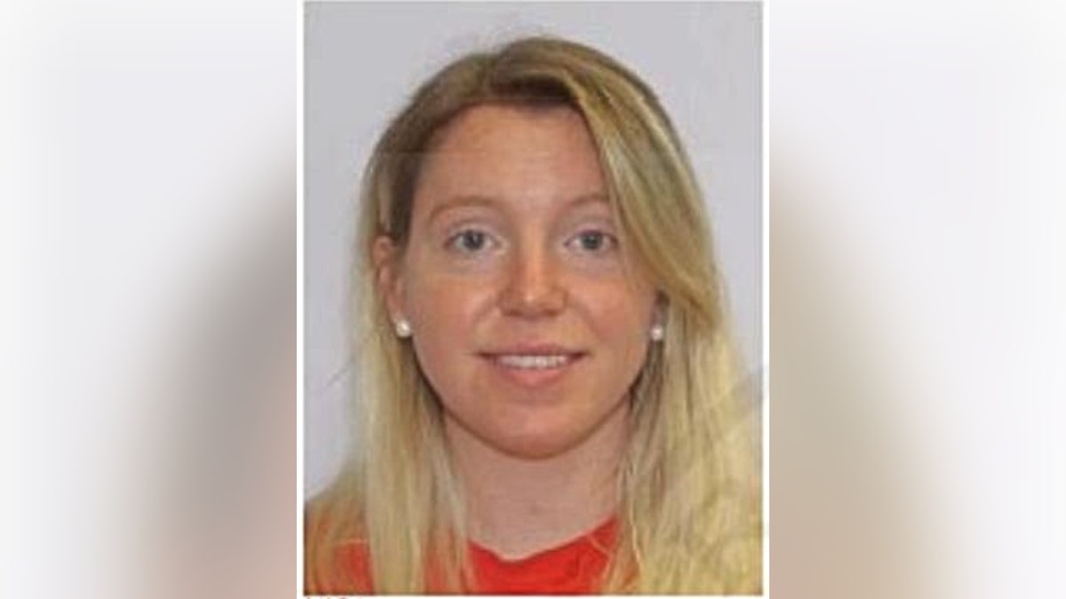 Kendra Wilson, who has blonde hair, wearing pearl earrings and a red shirt