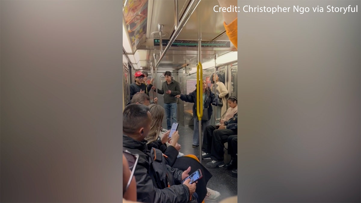 Woman lectures man in MAGA hat on NYC subway