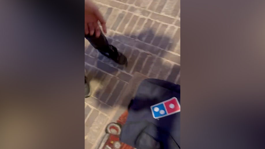 A pizza delivered to the door of alleged Austin Metcalf killer Karmelo Anthony's door.