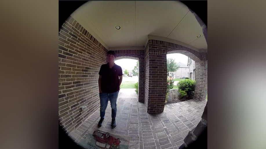 An unknown person at the door of Karmelo Anthony's residence