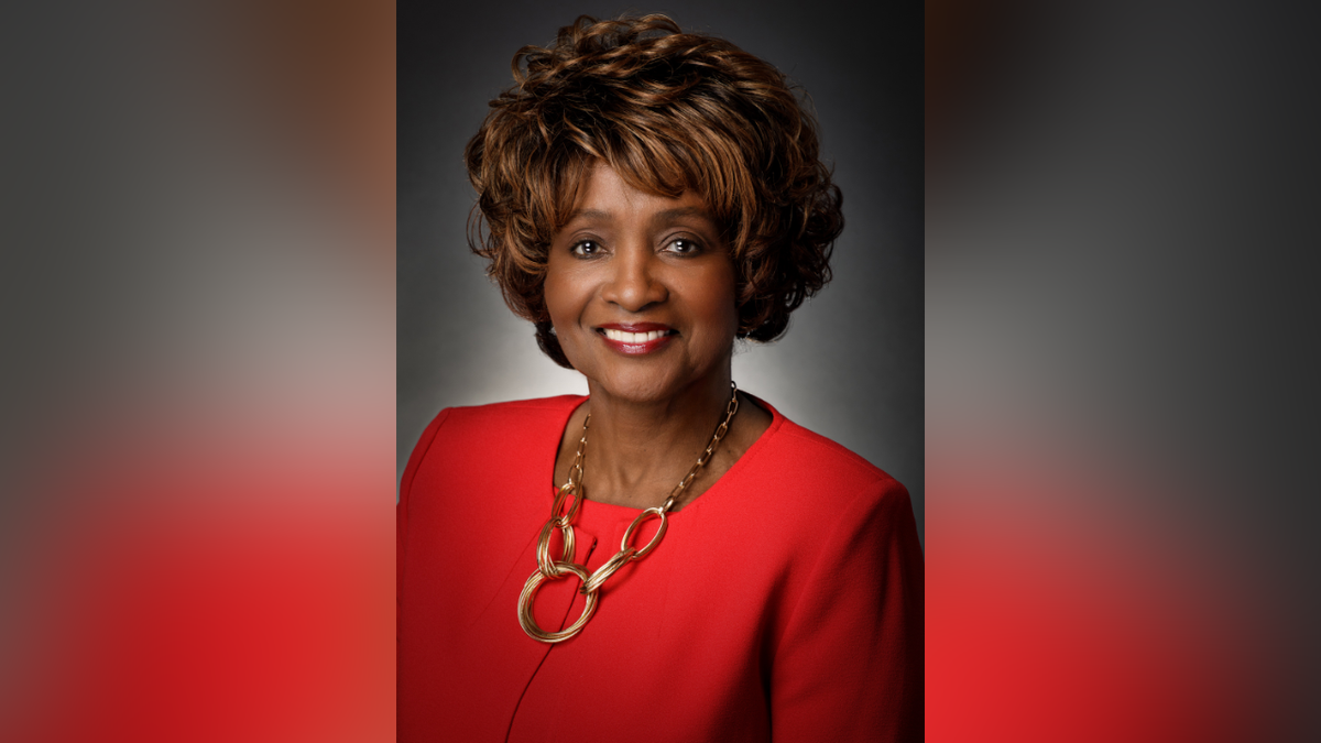 Denton County Commissioner Bobbie Mitchell poses for a picture in a red suit.