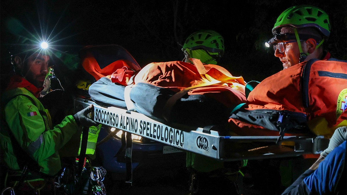 Rescuers transporting a body.