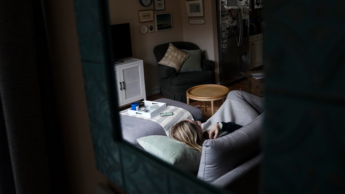 woman laying on couch