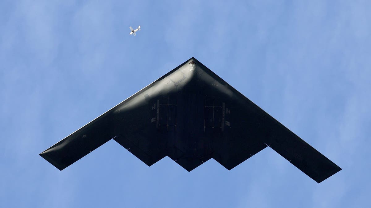 Pasadena, CA - January 01: A small plane is dwarfed by a Northrop Grumman B-2 Stealth Bomber flying over Colorado Blvd. in Pasadena Wednesday, Jan. 1, 2025. The B-2 is from Whiteman Air Force Base in Missouri