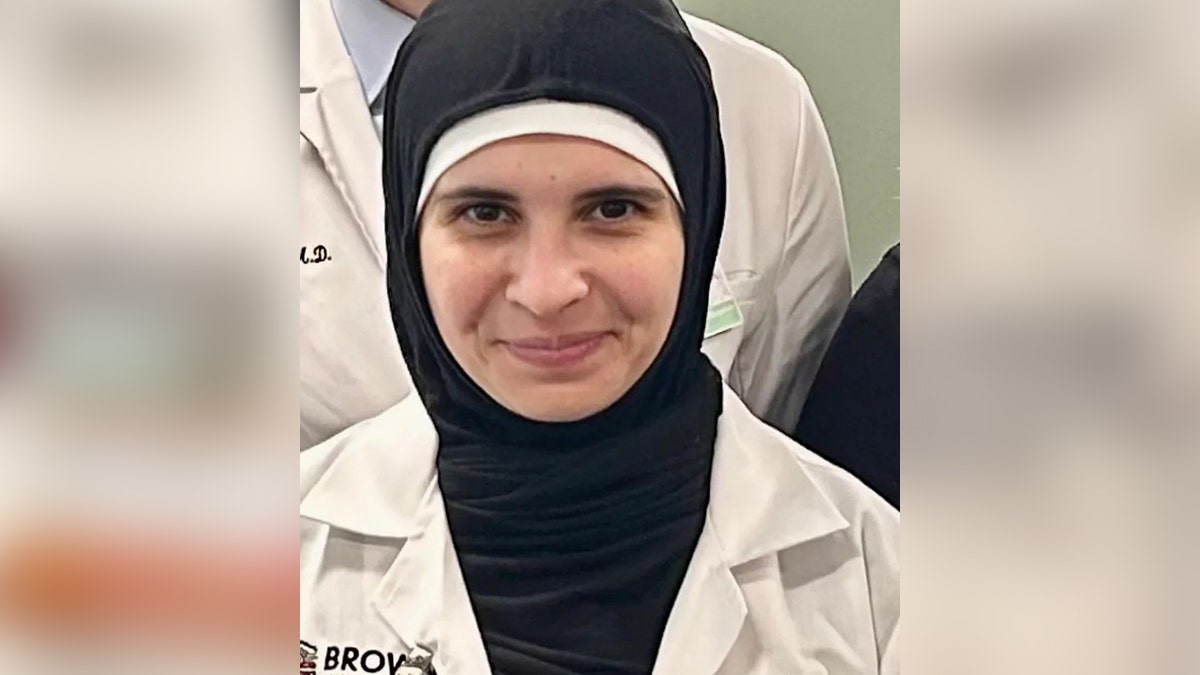 Dr. Rasha Alawieh seen in black headress and Brown Medicine's white doctor's coat at Rhode Island Hospital