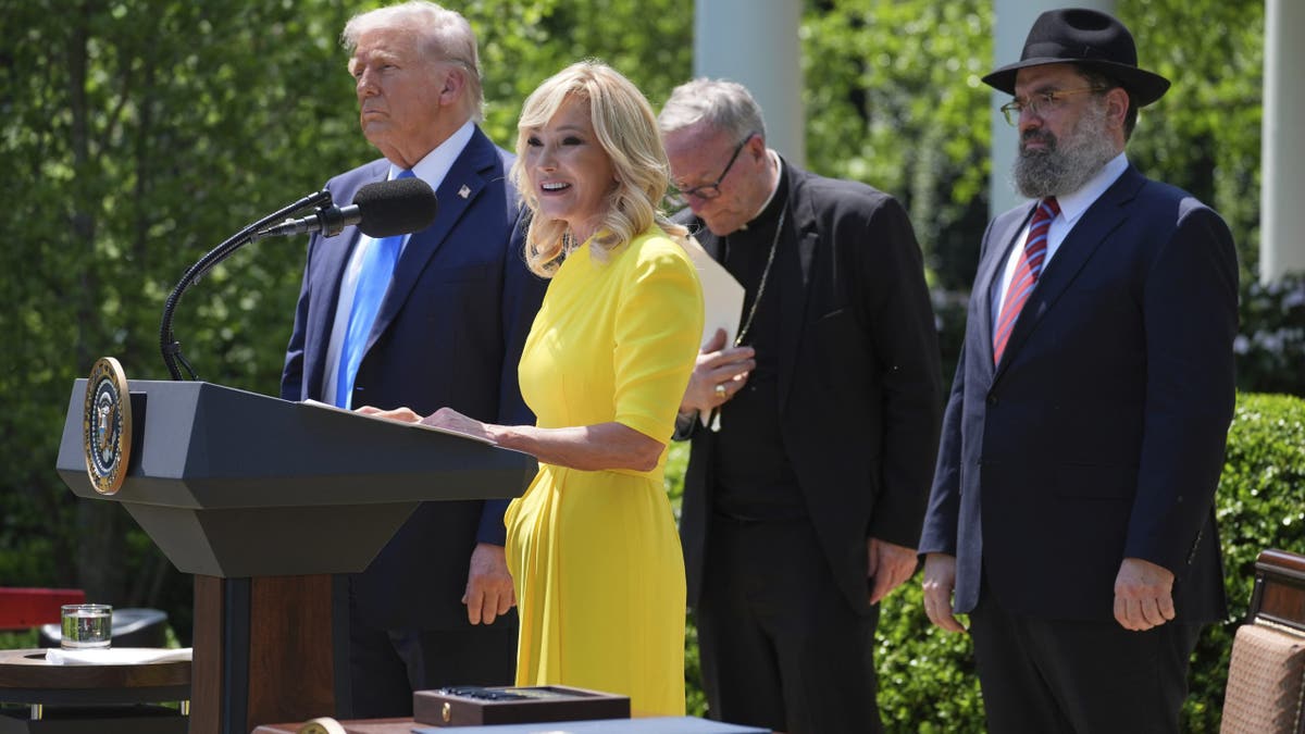 Pastor Paula White speaks as President Donald Trump, left, listens during a National Day of Prayer event in the Rose Garden of the White House, May 1, 2025, in Washington. 