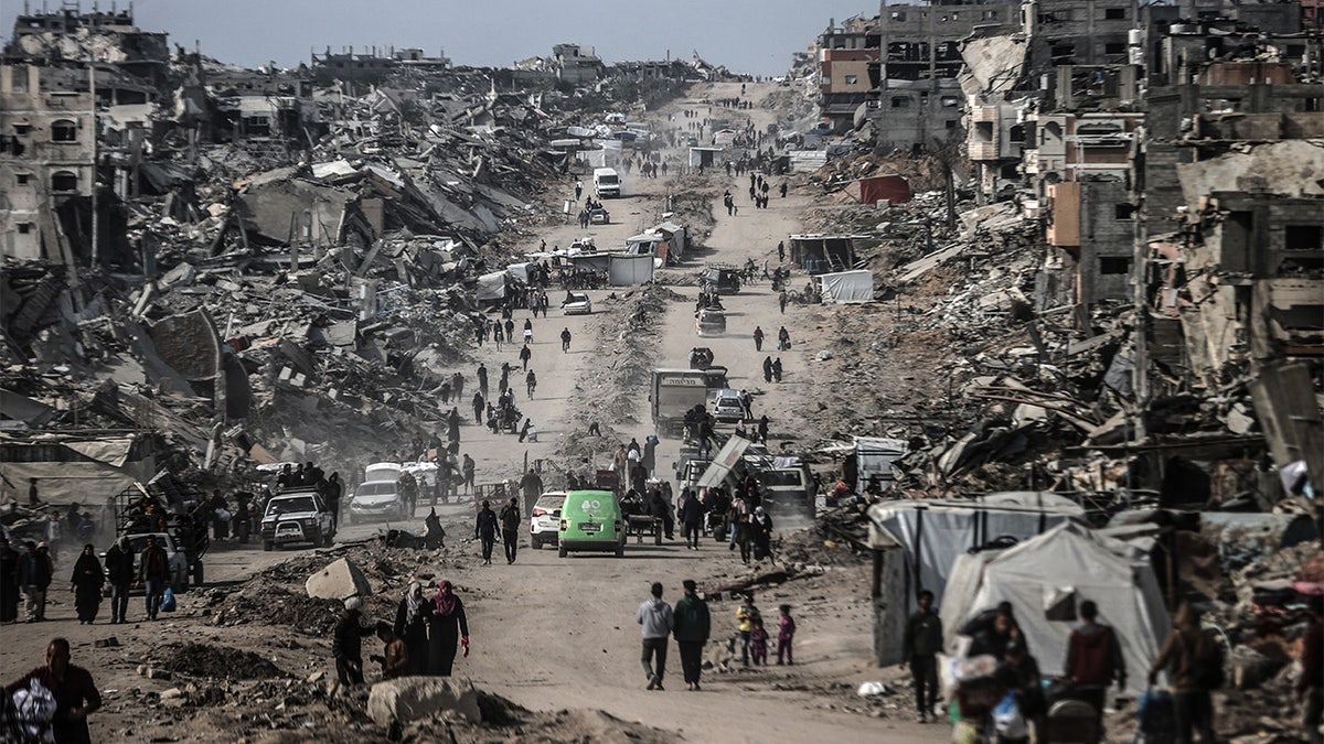 A general view of people walking about the rubble in Gaza city