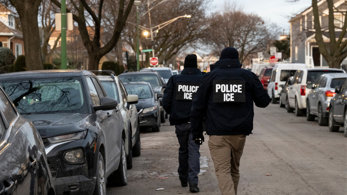ICE agents walking down a street