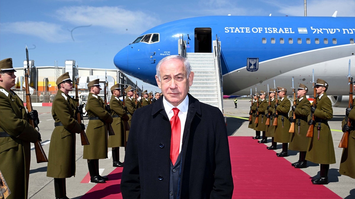 Benjamin Netanyahu with israeli plane and military in background