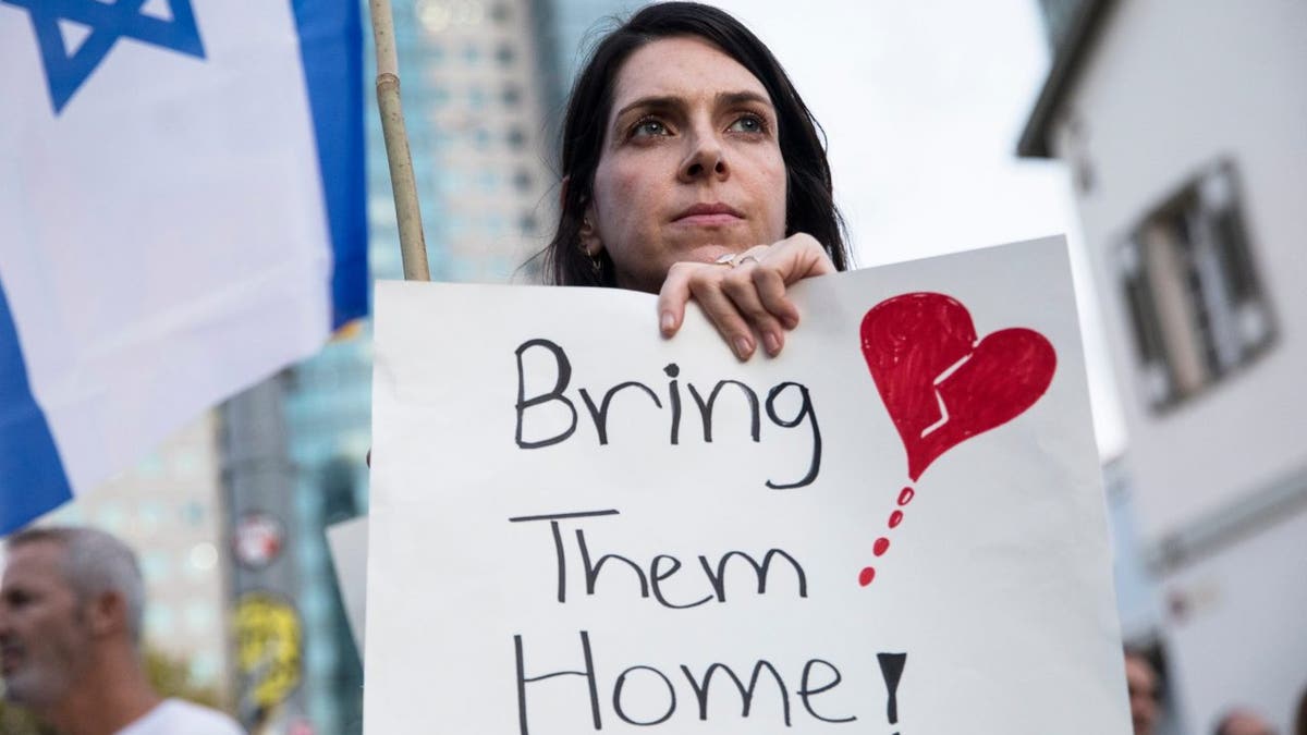 Woman holding sign