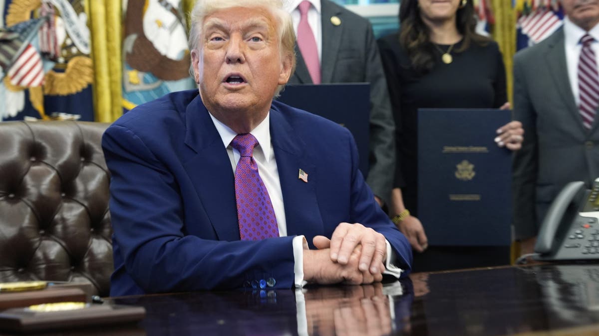 Trump at desk in Oval Office