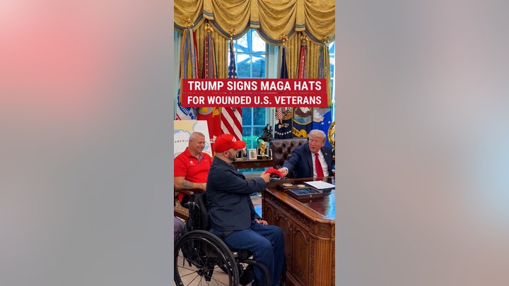 Trump signs MAGA hats for wounded U.S. veterans