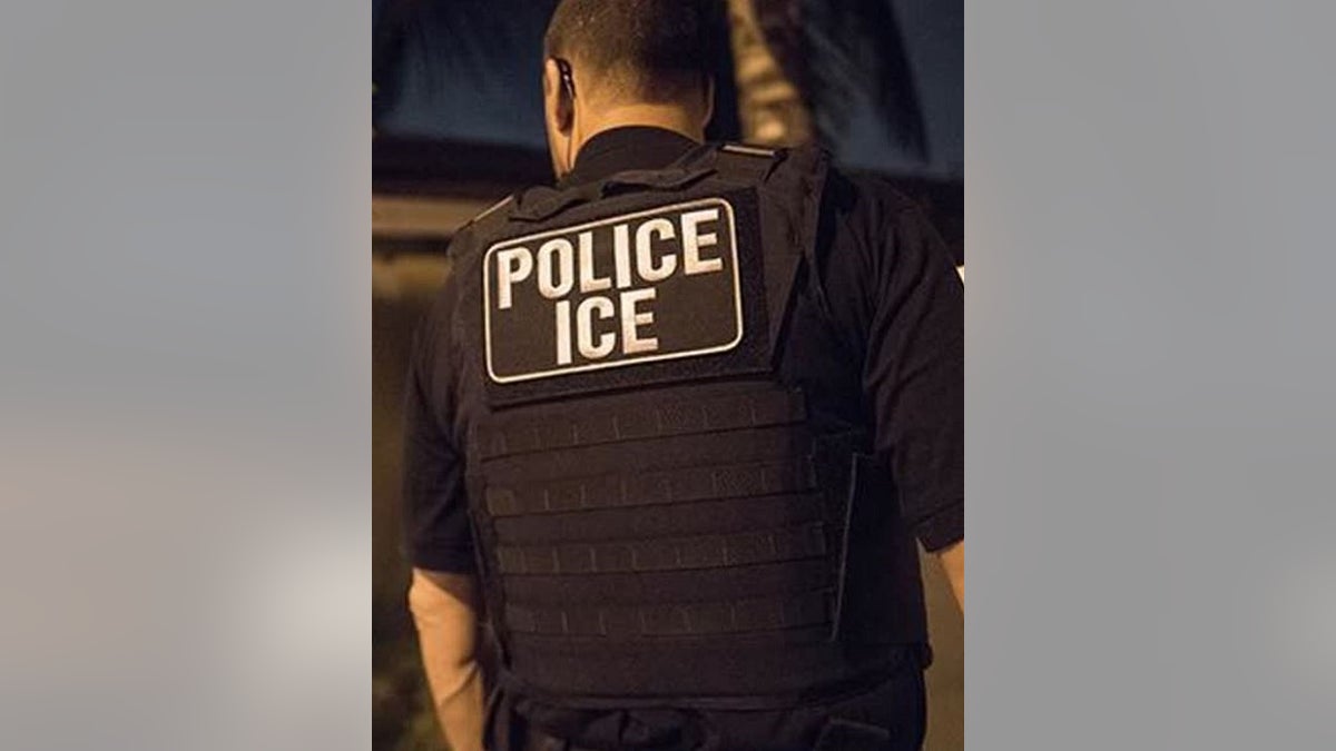 ICE officer seen from behind