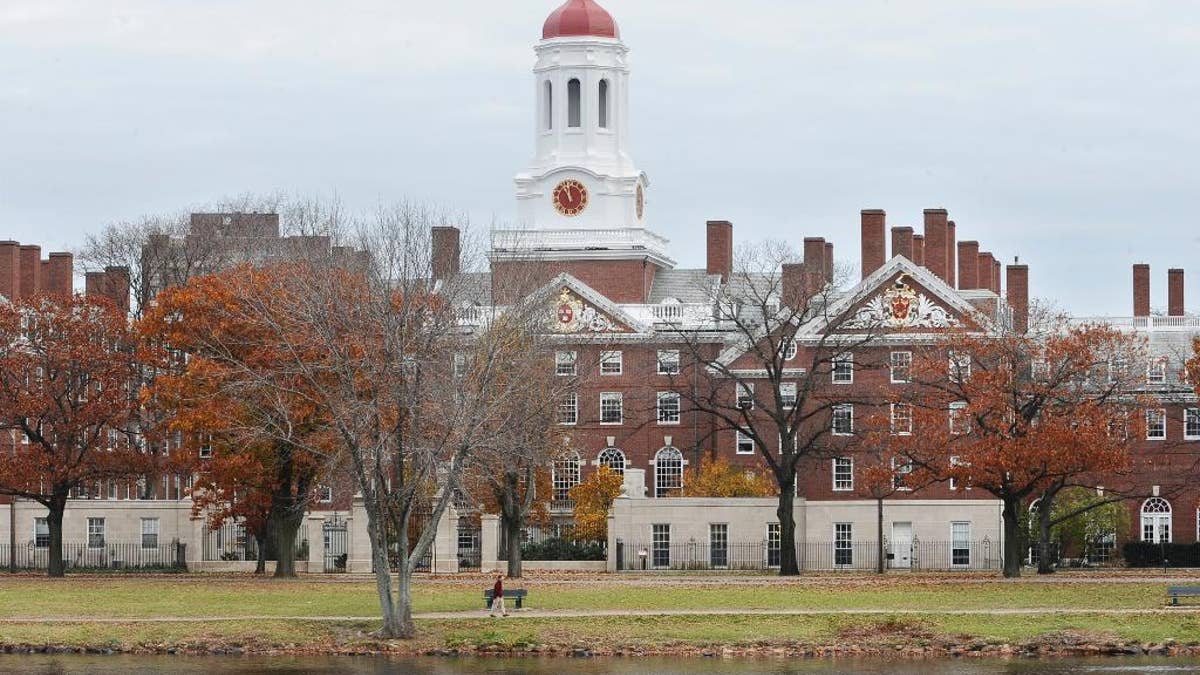 FILE - This Nov. 13, 2008 file photo shows the campus of Harvard University in Cambridge, Mass. Harvard University is taking new steps to confront its past ties to slavery. The Ivy League school is hosting a conference Friday, March 3, 2017, exploring the historical ties between slavery and early universities, including Harvard. (AP Photo/Lisa Poole, File)
