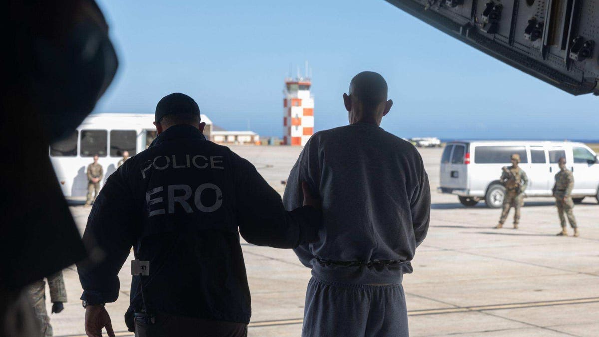 deportee escorted by officer