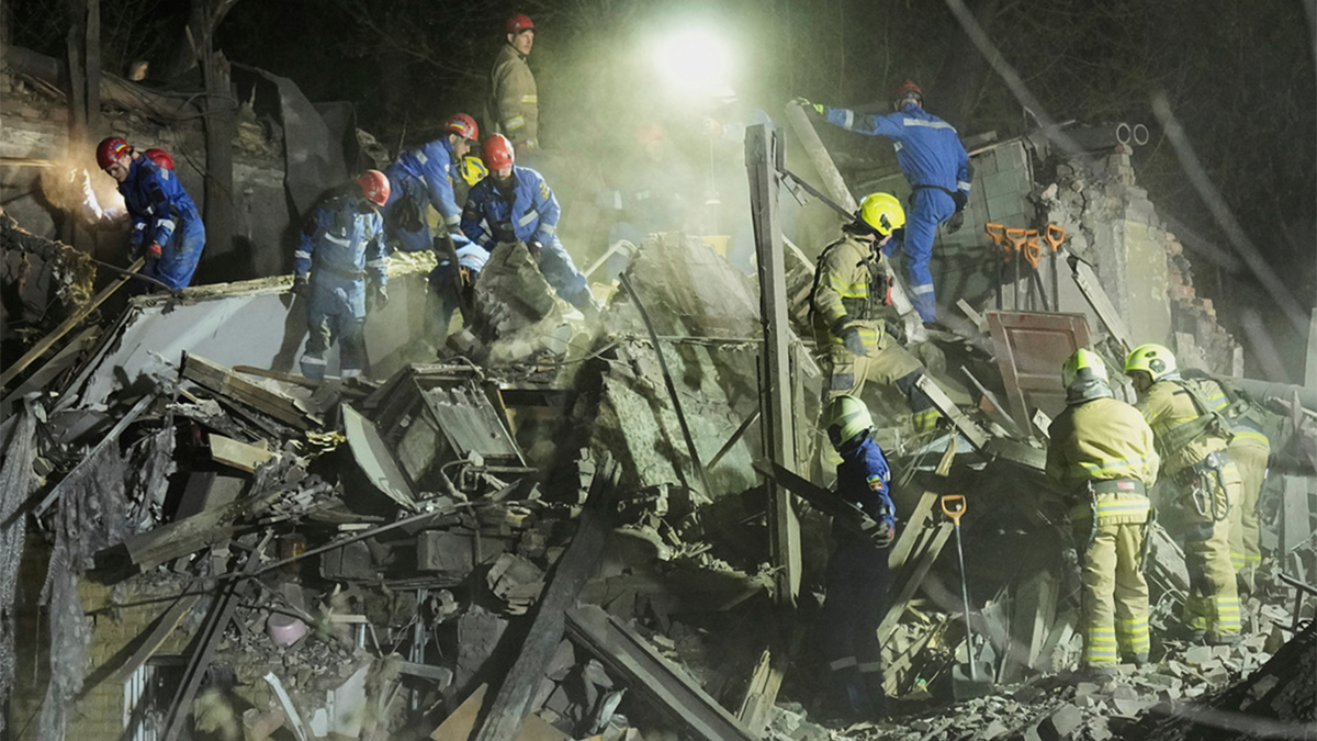 rescue workers dig through the rubble in Kyiv