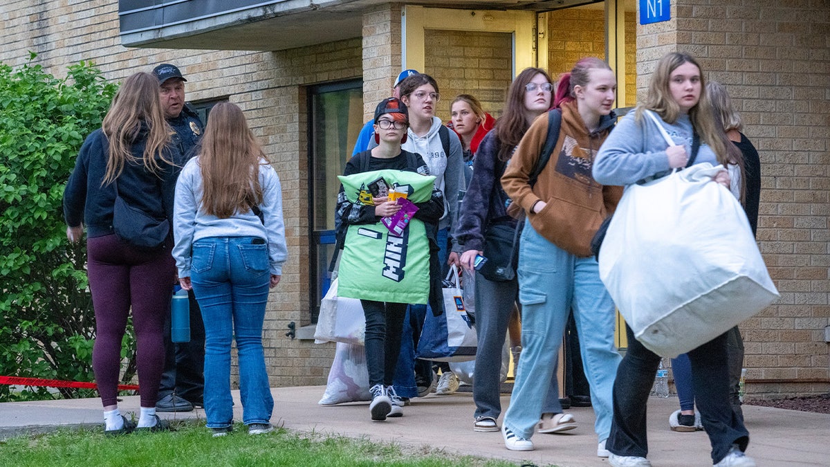 Students leave with their belongings from Wilgus Hall 