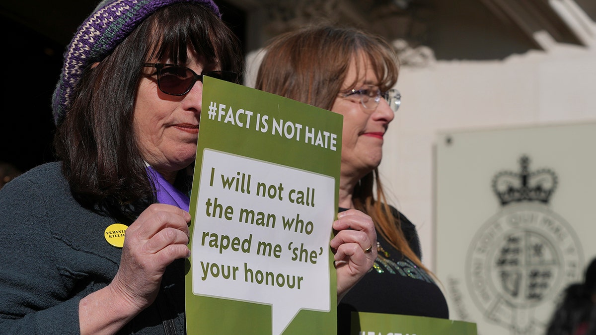 Women's rights activists hold signs outside court