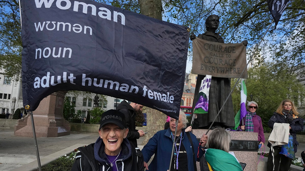 Women's rights activists hold signs outside court
