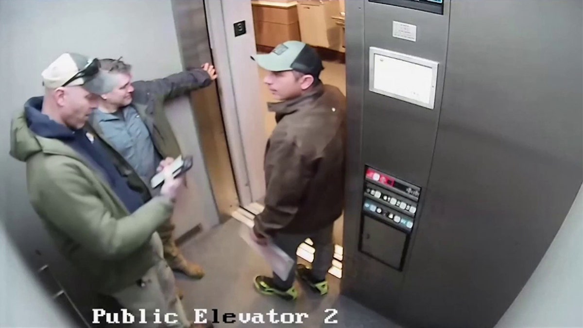 Agents talking to illegal immigrant in elevator
