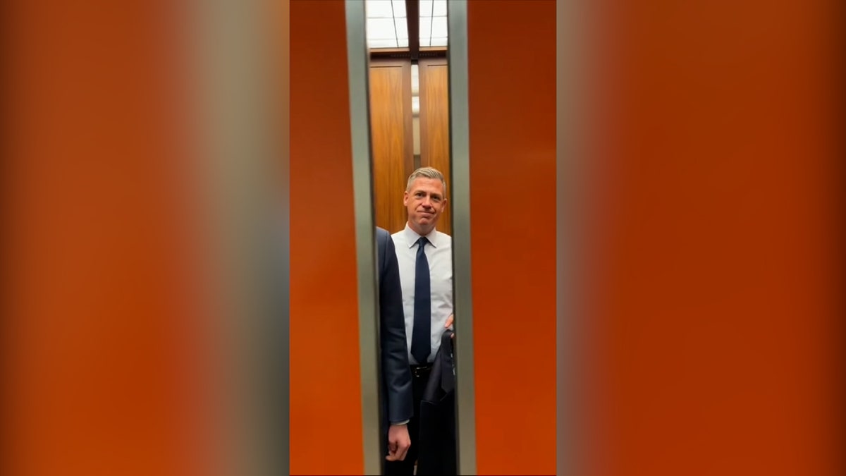 Sen. Jim banks in elevator smiling as doors close