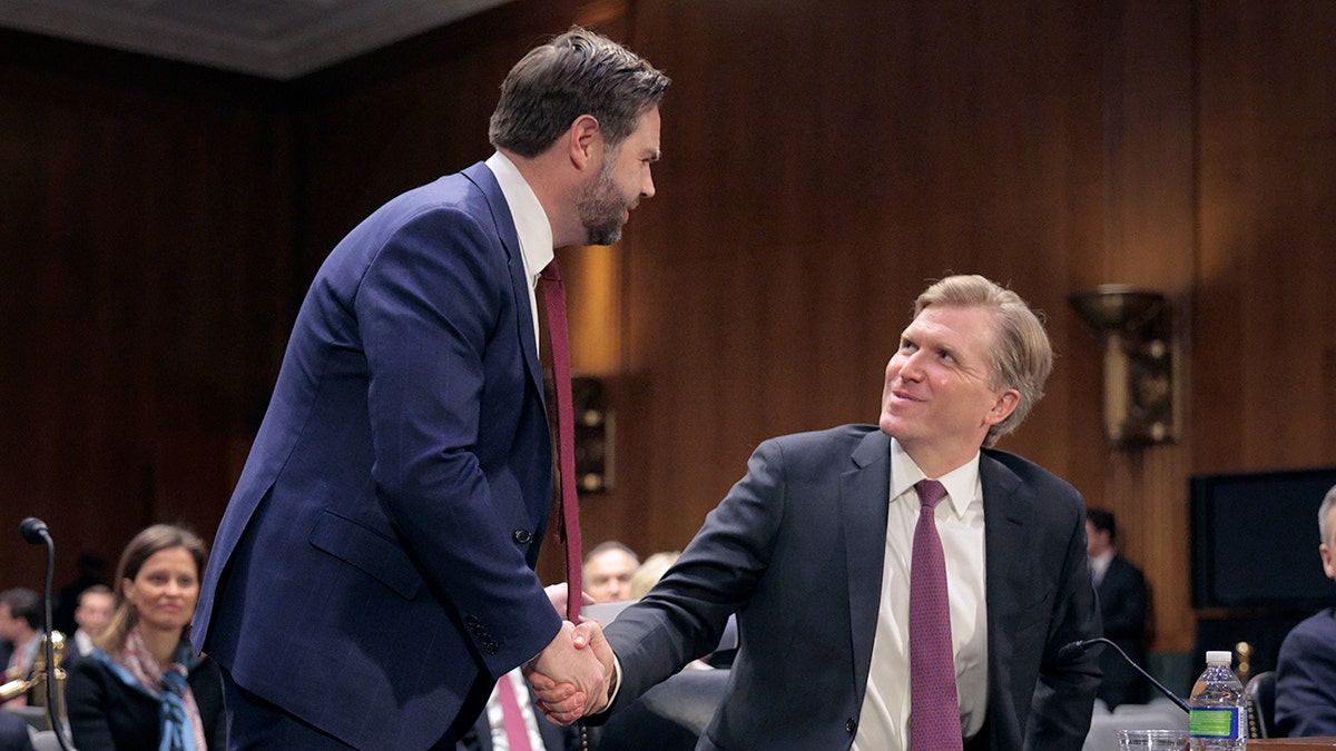 Vice President JD Vance shakes hands with Elbridge Colby