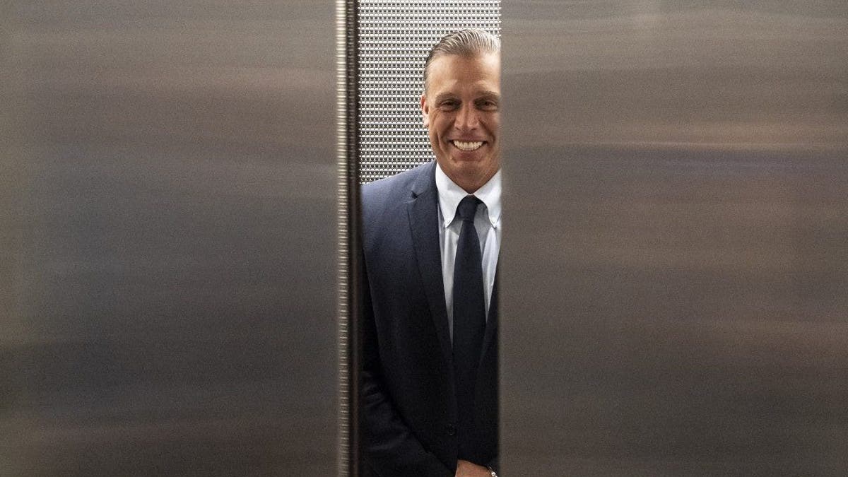 Devon Archer gets into an elevator