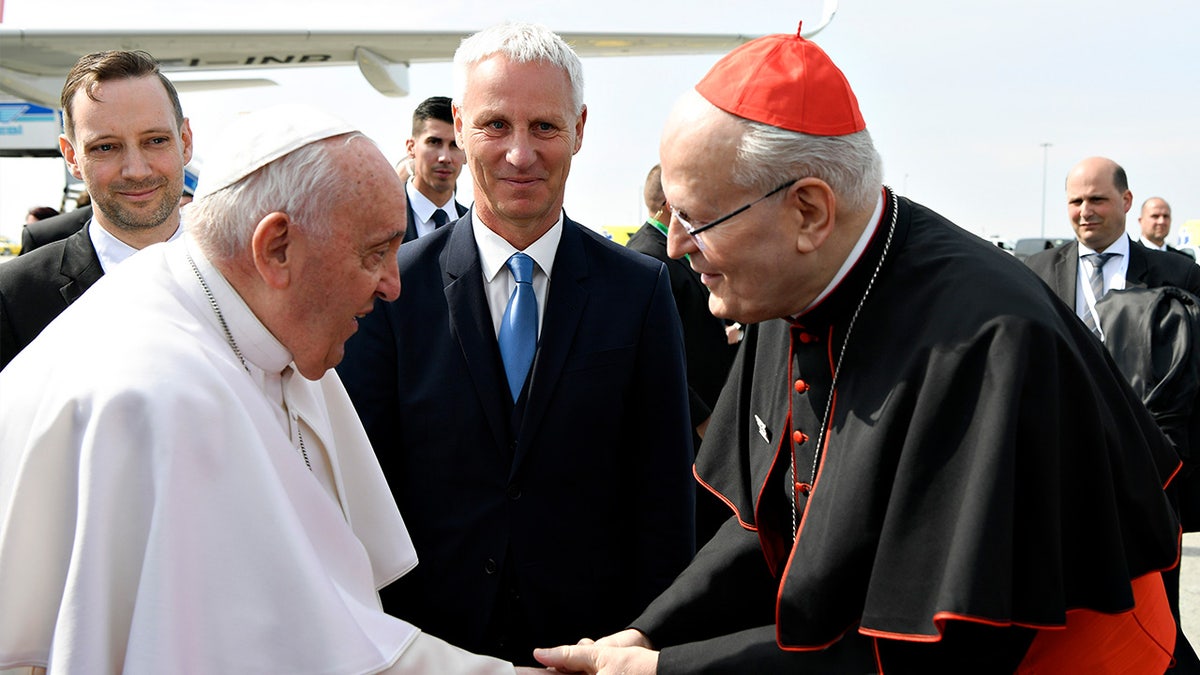 Pope Francis greets Cardinal Peter Erdo