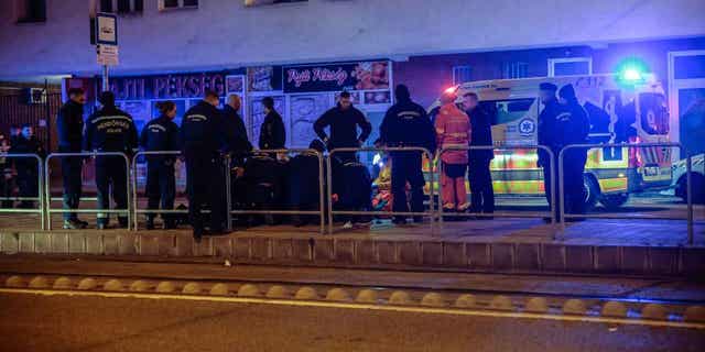 Police officers are pictured detaining an assailant in Budapest, Hungary, on Jan. 12, 2023. A police officer was fatally stabbed in Hungary’s capital. Two other officers were also stabbed but did not die.