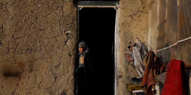 Sister of Amrullah, a three-month-old who died due to the cold, stands at her home in Kabul, Afghanistan, on Jan. 30, 2023.