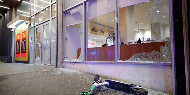Broken windows at a Wells Fargo branch are seen following a violent protest, late Saturday, Jan. 21, 2023.