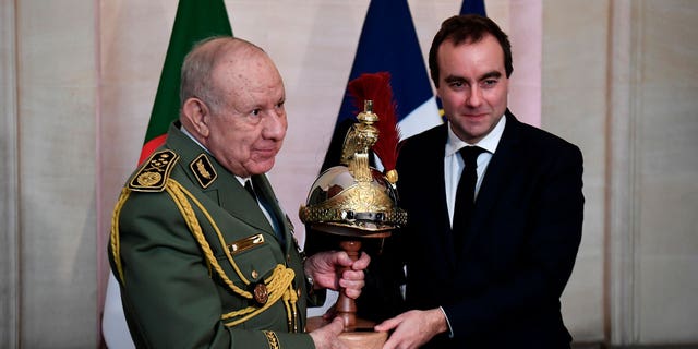 Algerian Army chief, Gen. Said Chanegriha, left, gets a present given by French Defense Minister Sebastien Lecornu, on Jan. 24, 2023 in Paris.