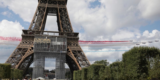 The French Aerial Patrol fly by the Eiffel Tower in Paris.