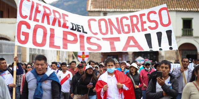 Demonstrators carry a sign reading, "Closure of the coup Congress," amid violent protests following the ousting and arrest of former President Pedro Castillo, in Ayacucho, Peru December 15, 2022. 