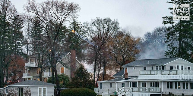 Firefighters battle a blaze at 725 Jerusalem Road in Cohasset, MA on Friday, January 7, 2023. The home once belonged to Ana Walshe who has been reported missing, last seen on New Year's Day.