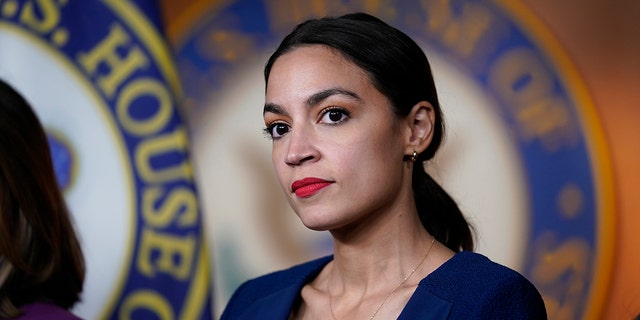  In this June 16, 2021, file photo U.S. Rep. Alexandria Ocasio-Cortez, D-N.Y., listens as House Speaker Nancy Pelosi, D-Calif., speaks during a news conference at the Capitol in Washington.