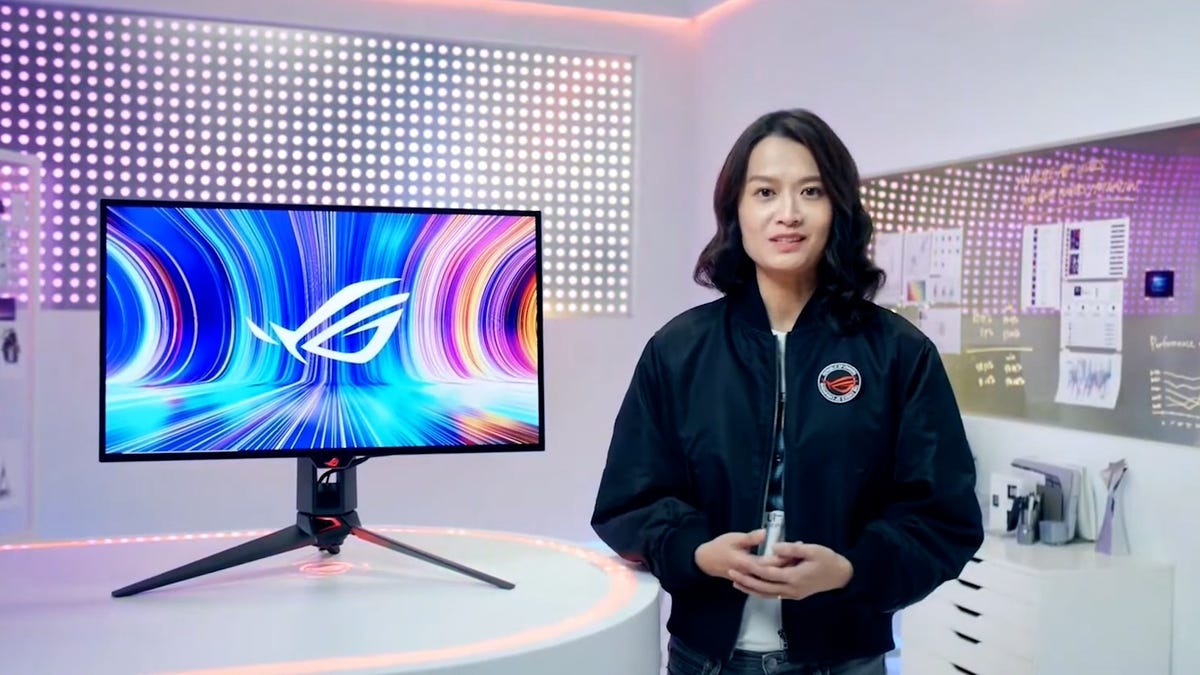 Asus PG27 OLED monitor on display with a woman presenter to its side