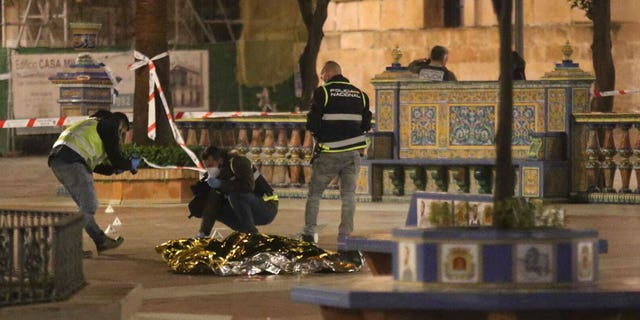 Police work next to the body of a man killed in Algeciras, southern Spain, on Jan. 25, 2023.