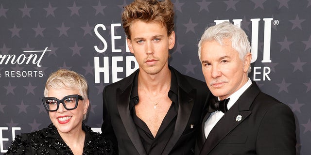 Austin Butler walks Critics Choice Awards red carpet with "Elvis" director Baz Luhrmann and costume designer Catherine Martin days after death of Lisa Marie Presley.