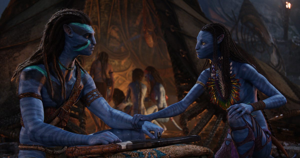Neytiri reaches out to touch Sully's arm in Avatar: The Way of Water