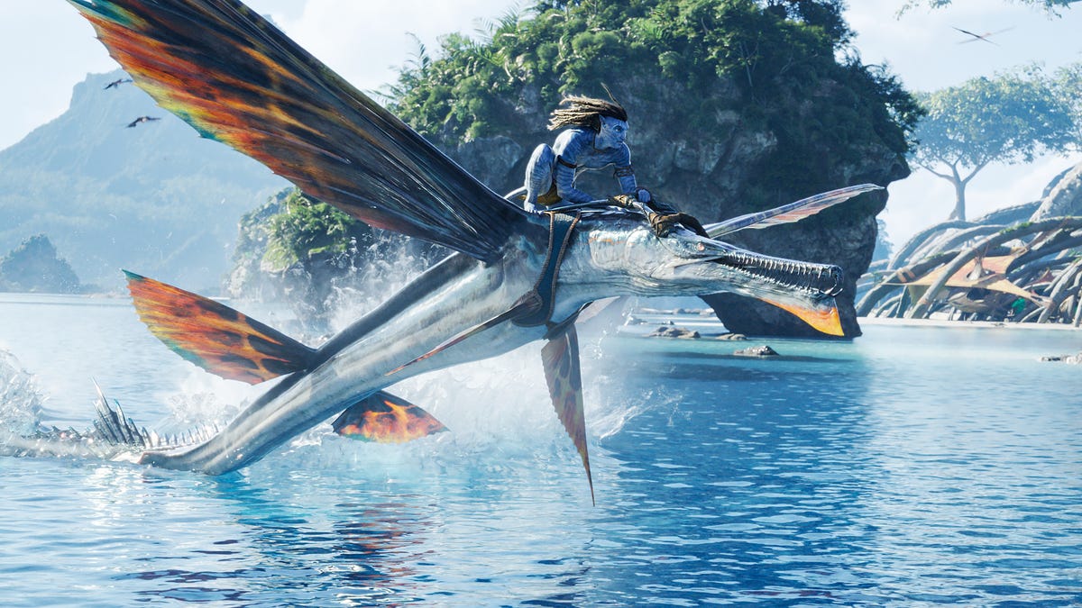 Jake Sully flies over Pandora's waters on a winged creature's back in Avatar: The Way of Water