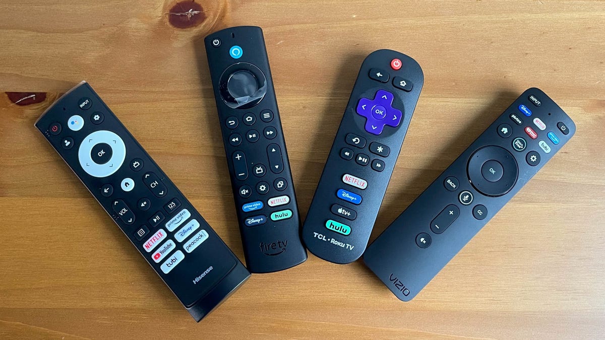 four remotes displayed on a table