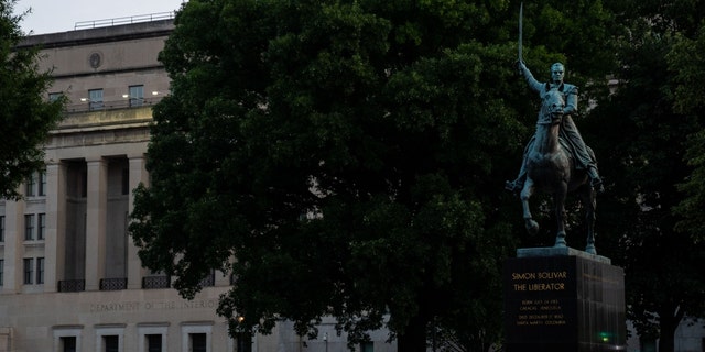 A statue of Simon Bolivar and the Stewart Lee Udall Department of the Interior Building, photographed on Friday, July 16, 2021, in Washington, D.C.