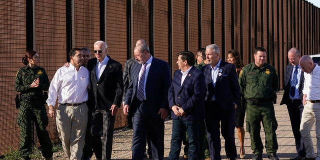 President Joe Biden talks with Rep. Henry Cuellar, D-Texas, second from left, as they walk along a stretch of the U.S.-Mexico border in El Paso Texas, Sunday, Jan. 8, 2023. Homeland Security Secretary Alejandro Mayorkas is at right. 