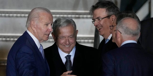 U.S. President Joe Biden is greeted at his arrival by Mexican President Andres Manuel Lopez Obrador, second left, Mexican Foreign Minister Marcelo Ebrard, second right, and U.S. Ambassador to Mexico Ken Salazar, right, at Biden's arrival to the Felipe Angeles international airport in Zumpango, Mexico, Sunday, Jan. 8, 2023. 