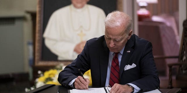 President Biden signs the condolence book for Pope Emeritus Benedict XVI at the Apostolic Nunciature of the Holy See in Washington, D.C., Thursday, Jan. 5, 2023.