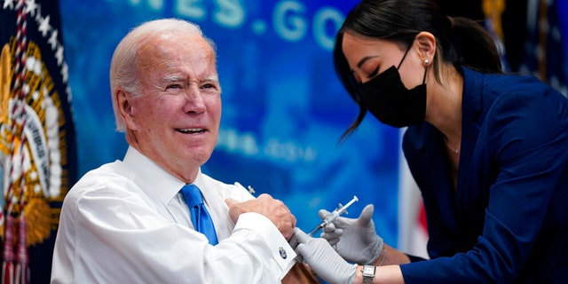 President Joe Biden receives his COVID-19 booster from a member of the White House medical unit during an event in the South Court Auditorium on the White House campus, Tuesday, Oct. 25, 2022, in Washington.