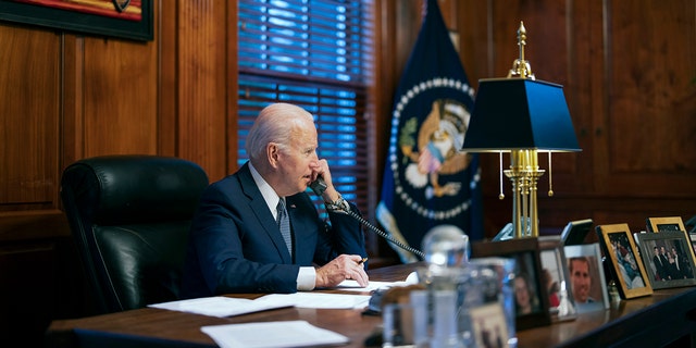 FILE - In this file image provided by The White House, President Joe Biden speaking on the phone from his private residence in Wilmington, Del., Dec. 30, 2021. 